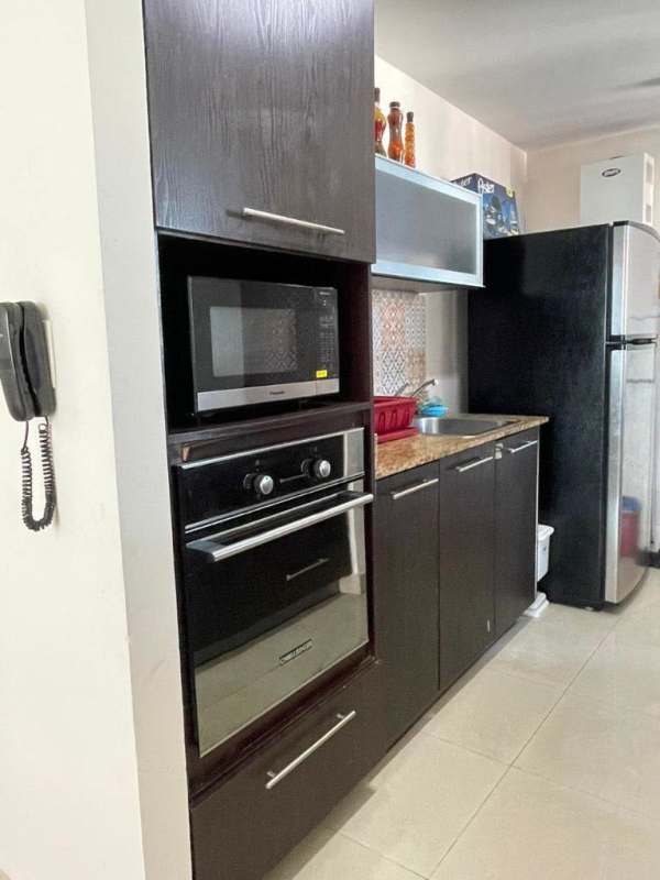 Modern kitchen with granite, microwave oven refrigerator tile backsplash Costa del Este Panama