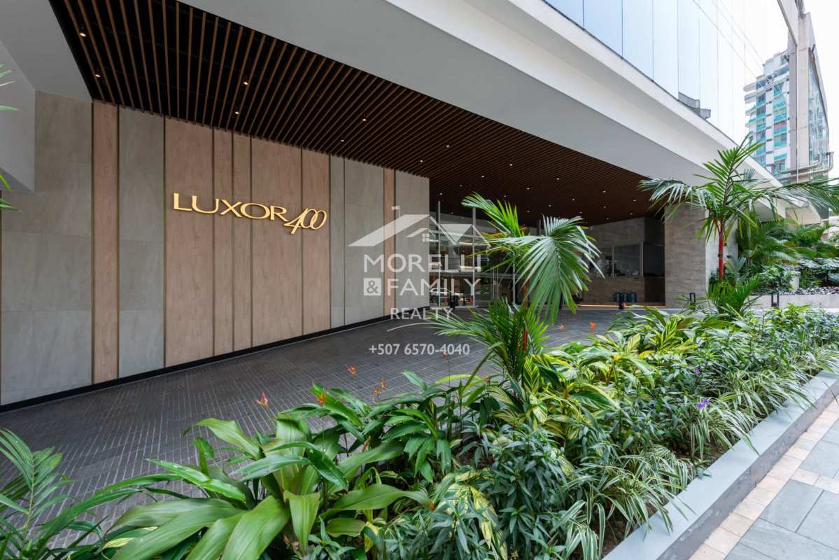 Luxurious entrance of PH Luxor 400 with glass facade and landscaped areas in El Cangrejo Panama City