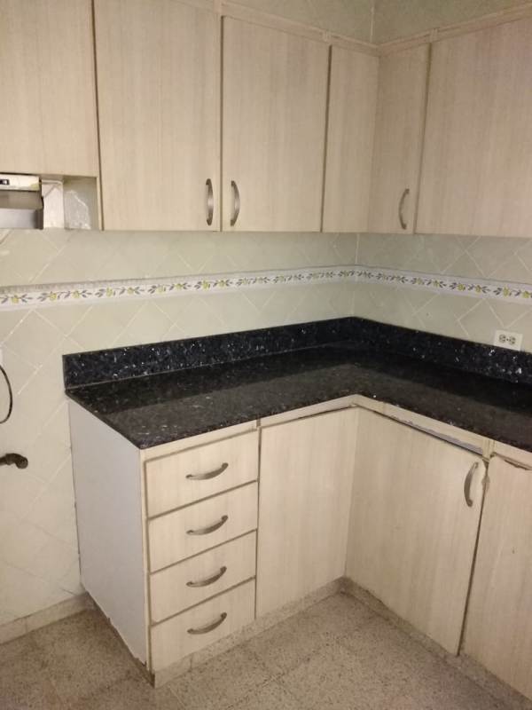 Kitchen with granite countertop tile backsplash cabinets PH Gina Obarrio