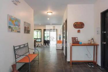 Bright open concept living dining with wood beams, tile floors, mountain views in Panama lodge