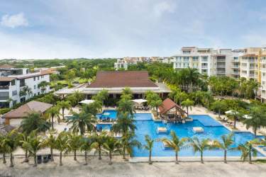 Aerial of beachfront pools, ocean and condos Buenaventura resort Panama