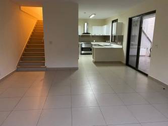 Bright open-plan living with kitchen and staircase River Valley Panama Pacifico