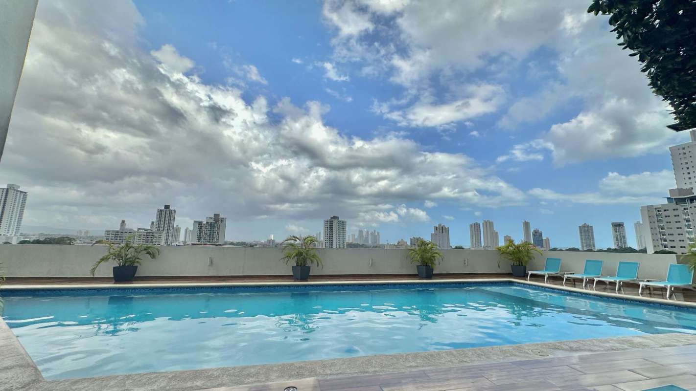 Rooftop swimming pool with lounge chairs overlooking Panama City from PH Coral Tower Carrasquilla