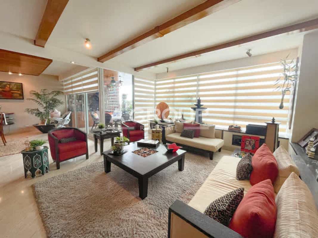Bright living room with wide windows balcony view cream sofas wooden ceiling PH Peninsula Punta Paitilla