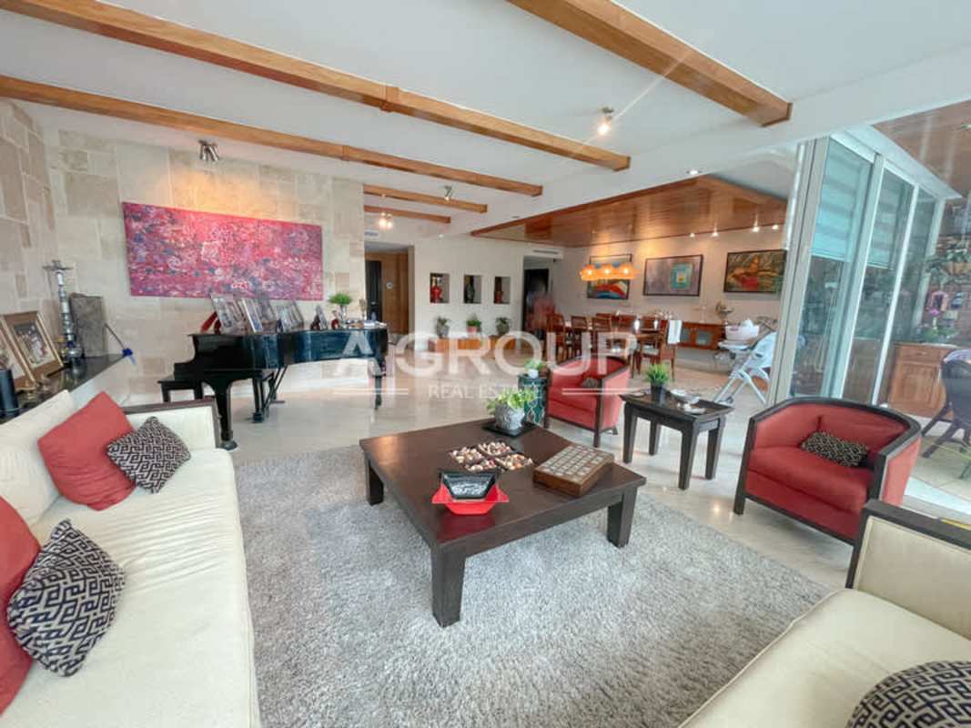 Large open living dining area glass doors exposed wood beams PH Peninsula Punta Paitilla Panama