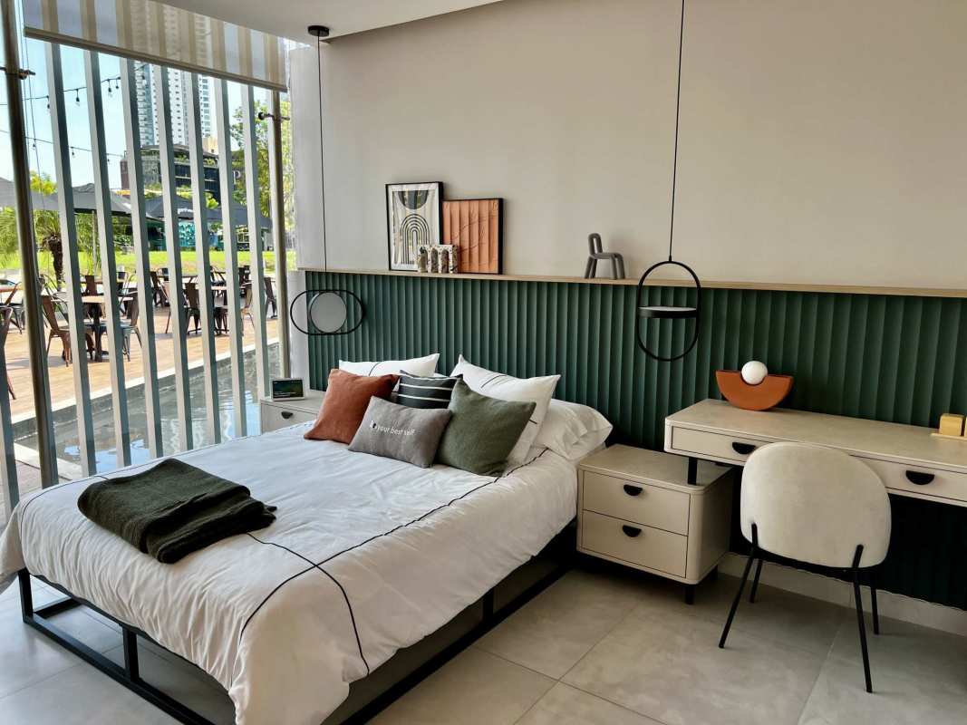 Minimalist bedroom with green accent wall in Costa del Este investment condo