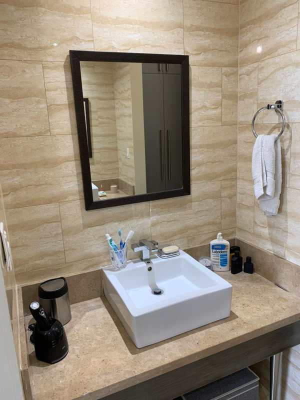 Elegant full bathroom with granite vanity, modern sink, glass walk-in shower at Denovo Tower in Obarrio