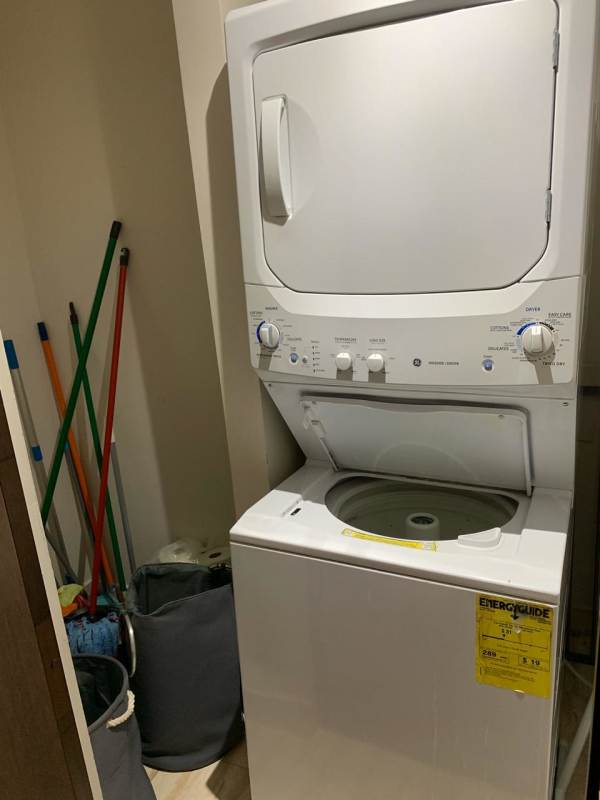 Modern bedroom with large city view window and wood floors at PH Denovo Obarrio Panama