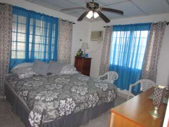 Formal dining room with chandelier and wooden furniture for sale house in Santiago Panama