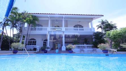 Coastal bedroom with two bunk beds, arched windows, blue curtains at Coronado Golf villa Panama
