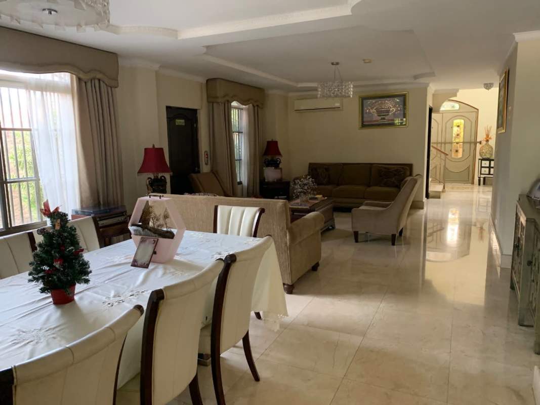 Bright open living and dining space with marble floors and classic furniture Chanis Panama