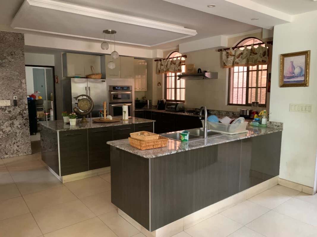 Modern spacious kitchen with stainless appliances, granite countertops and double island in luxury house Panama City