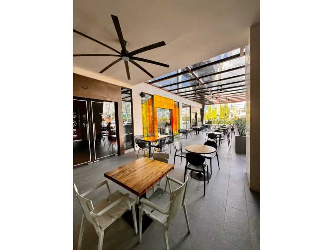 Covered outdoor seating with fan and orange accents at San Francisco commercial Plaza Panama City
