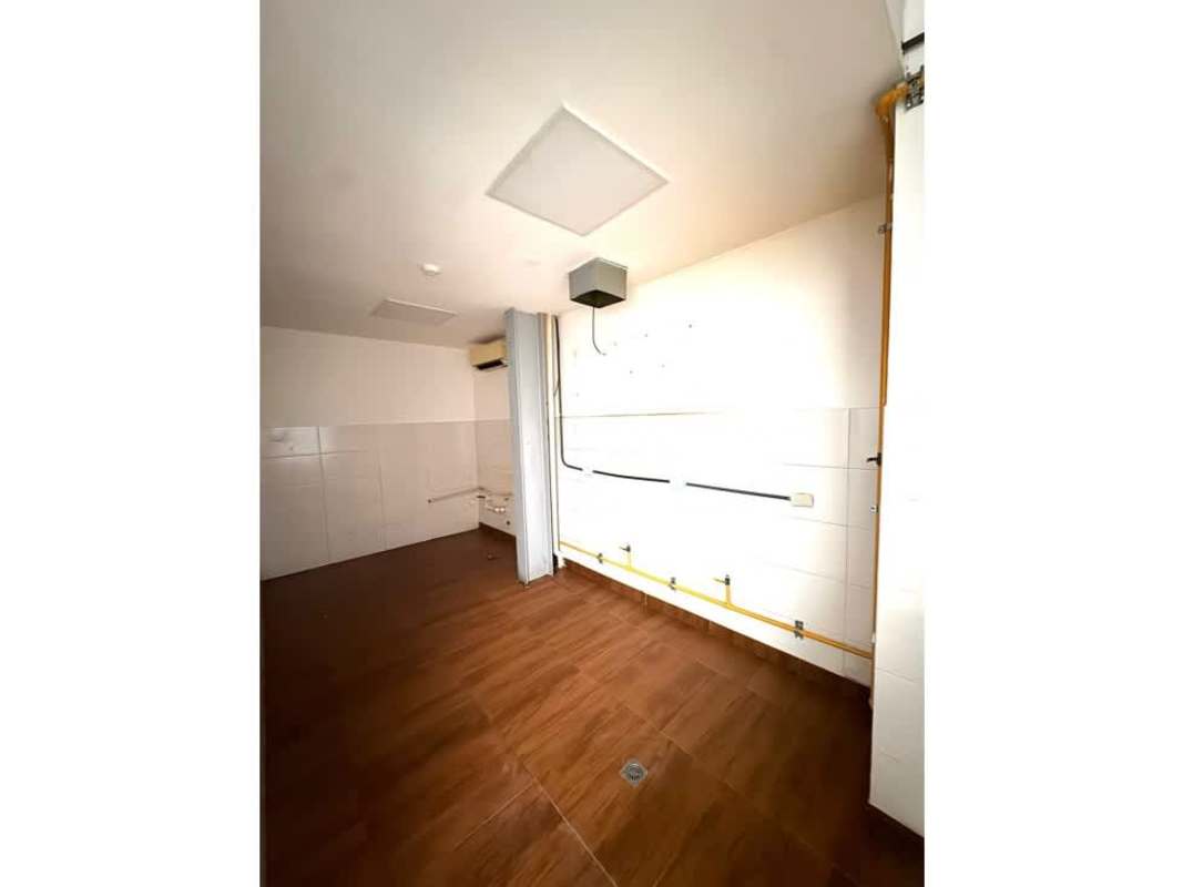 Empty room with wood floor, sloped ceiling and large wall mural San Francisco Commercial Plaza