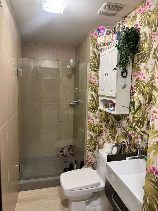 Dining room with glass table, pink transparent chairs and decor at PH Colores Bella Vista Panama City