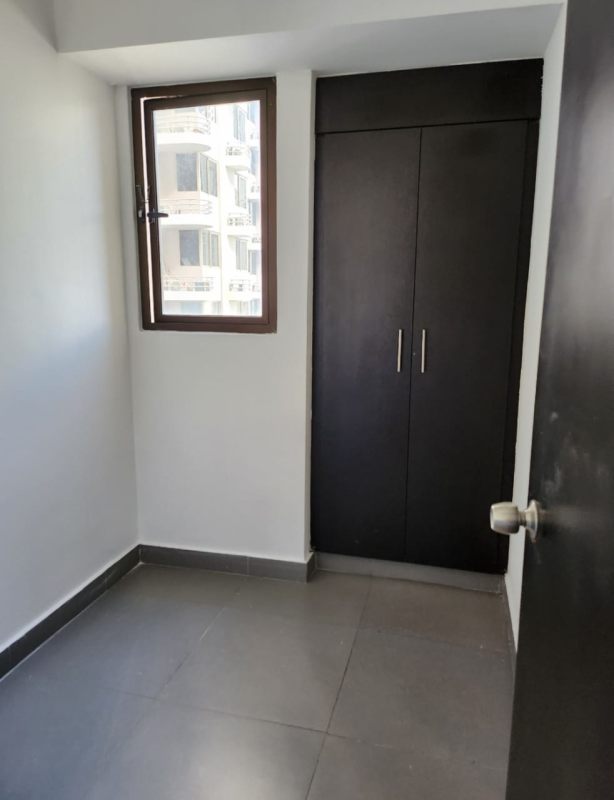 Bright bedroom featuring floor-to-ceiling windows with view of Panama City and Pacific Ocean