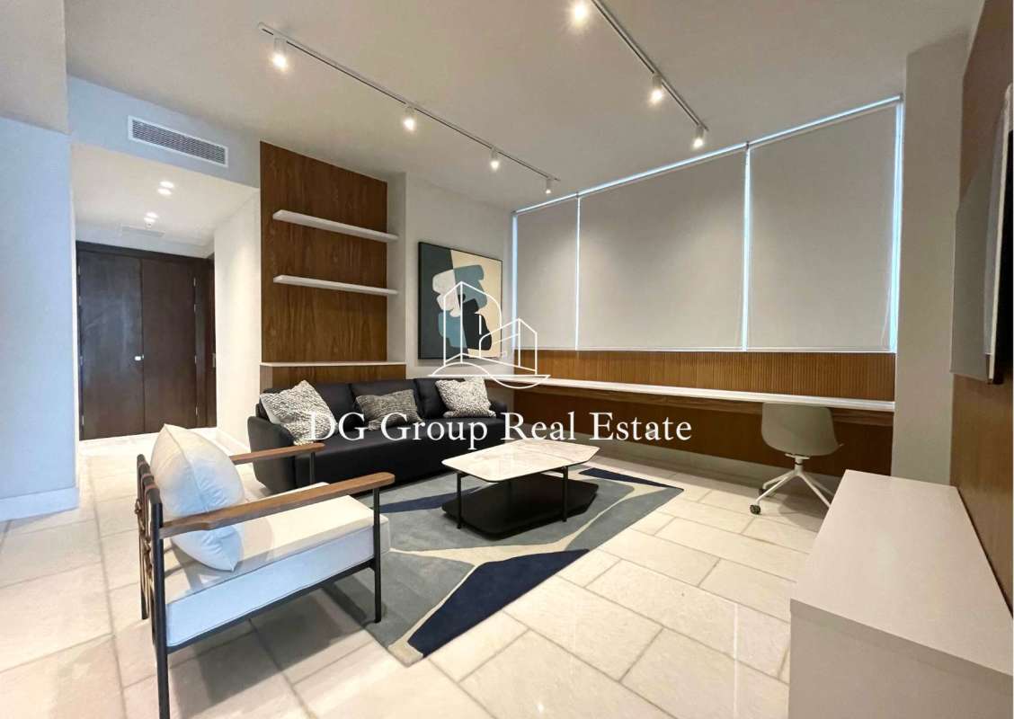 Living room with TV wall unit, marble floors and built-in shelving in The Towers luxury apartment Punta Paitilla
