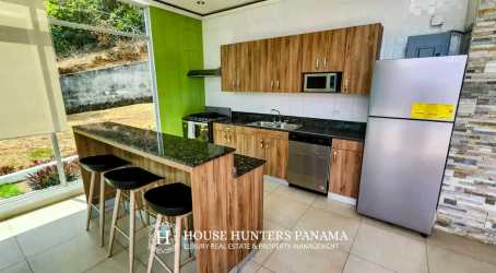 Modern mountain kitchen with island stainless appliances granite counters Panama