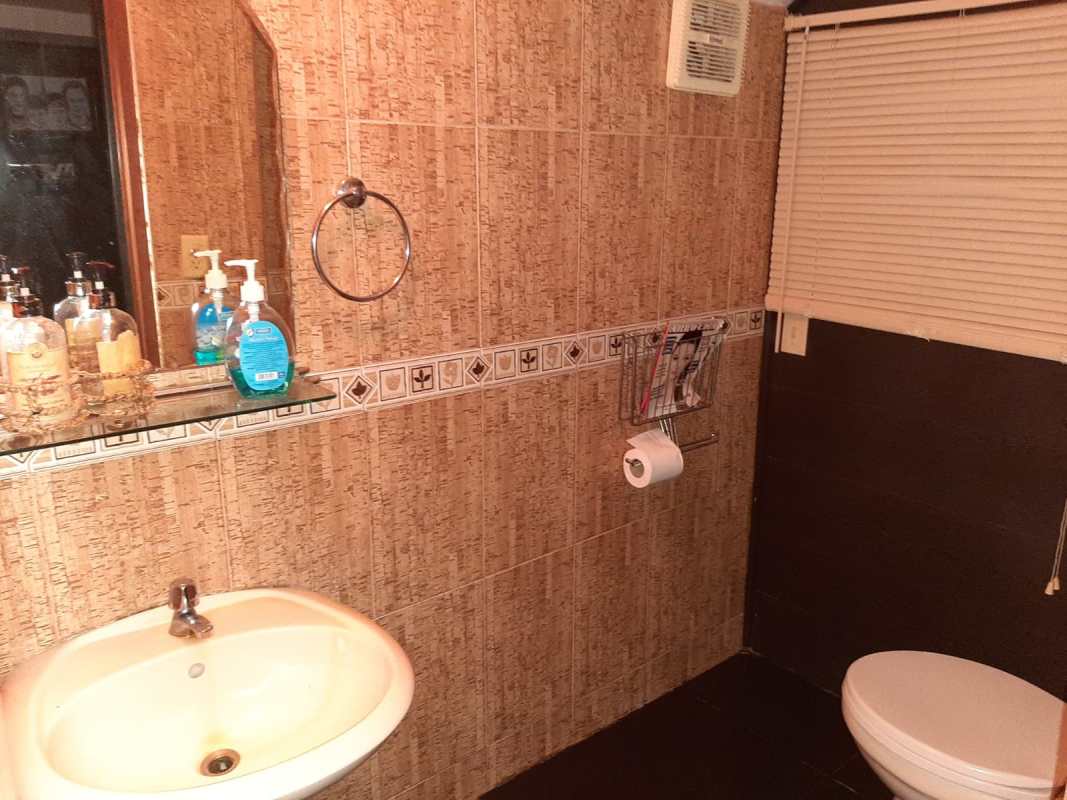 Kitchen with tiled counters, double sink, and wood cabinets in Albrook house