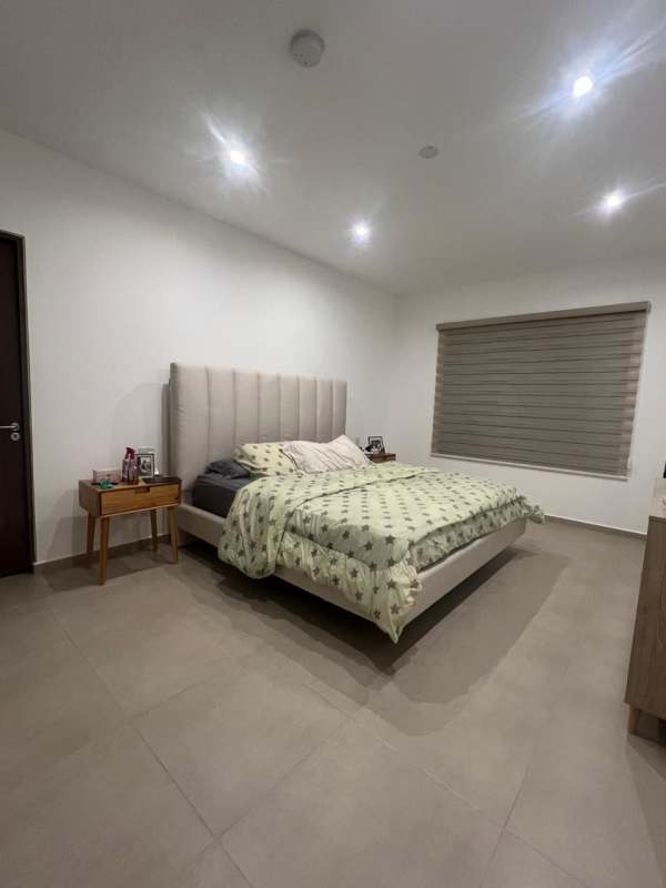 Minimalist dining room with glass table overlooking gardens in Golf Gardens Panama City