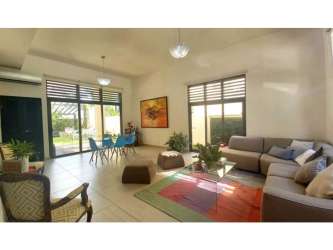 Bright living area with large windows overlooking garden in PH Nativa Panama Pacifico
