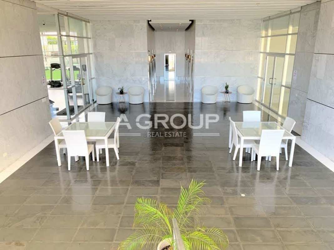Modern double-height lobby with glass walls and marble finishes PH Waters on the Bay Panama