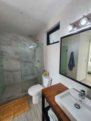 Luxury bathroom with glass-enclosed shower modern vanity Punta Caelo Panama