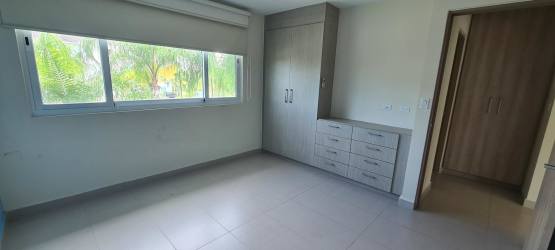 Guest bedroom with closets and tile floors Bijao Quarry Heights condo Panama