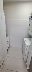 Laundry area with utility sink storage at Bijao Quarry Heights apartment Panama