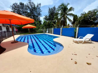 Covered outdoor palapa lounge with BBQ grill, seating at Punta Chame beach house rental Panama