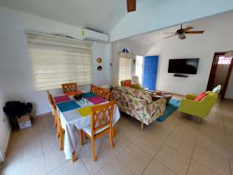 Spacious open living and dining room with ceiling fans, tile floors in Punta Chame beach house rental Panama