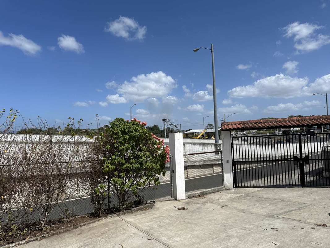 Gated commercial lot entrance with concrete pavement Las Cumbres Panama