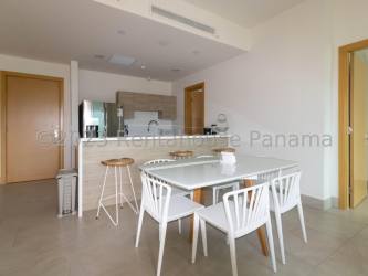 Minimalist bedroom with twin beds and ocean view window in Playa Escondida condo Colon Panama