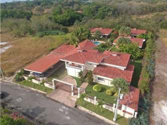 Secure gated entrance with driveway, palm trees and landscaped garden Santa Clara Panama