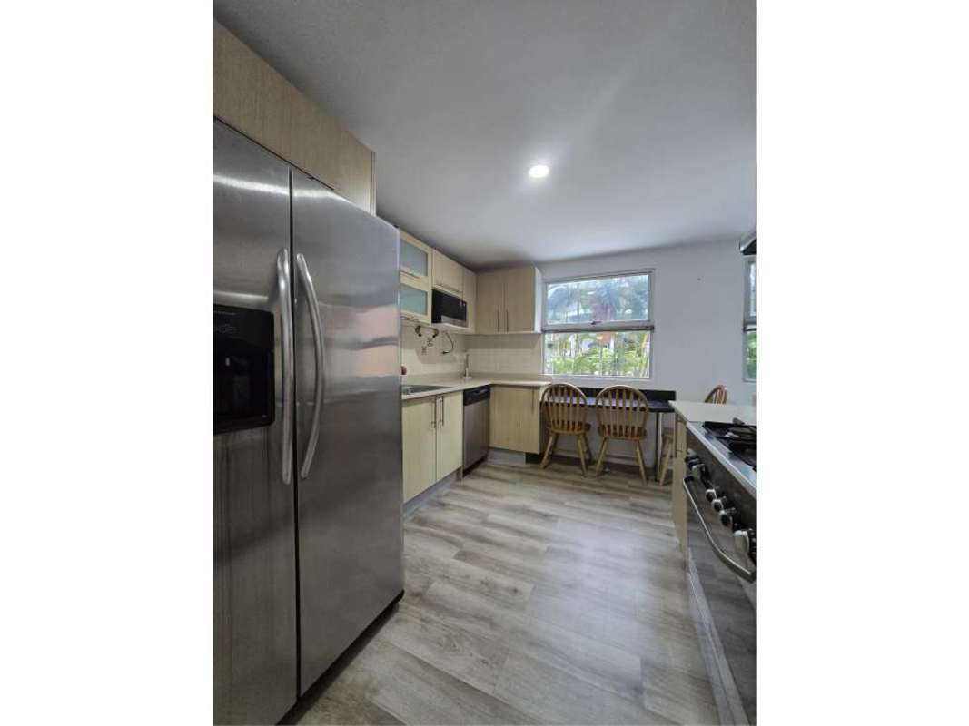 Kitchen with modern appliances, wooden cabinets, large windows PH Clayton Tower Clayton Panama