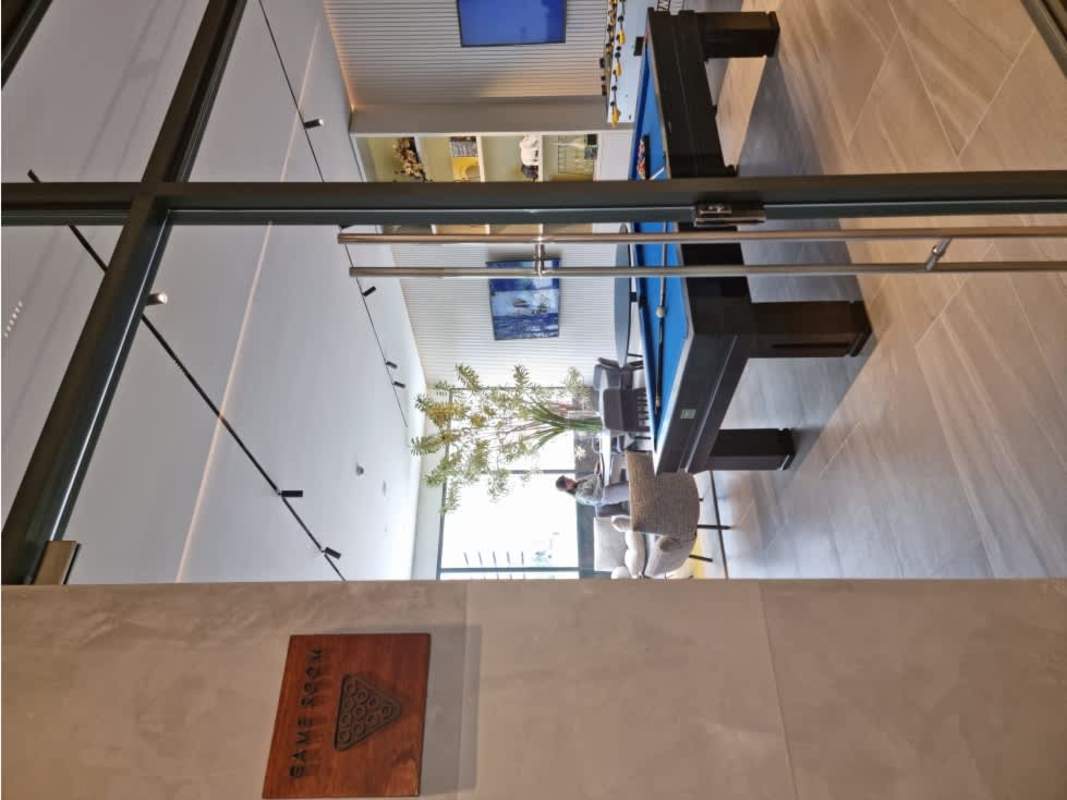 Game room entertainment area with billiards, foosball, TV Ocean House Santa María Panama