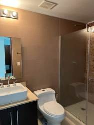Contemporary bathroom with glass shower and tile design in Panama Pacifico apartment for sale