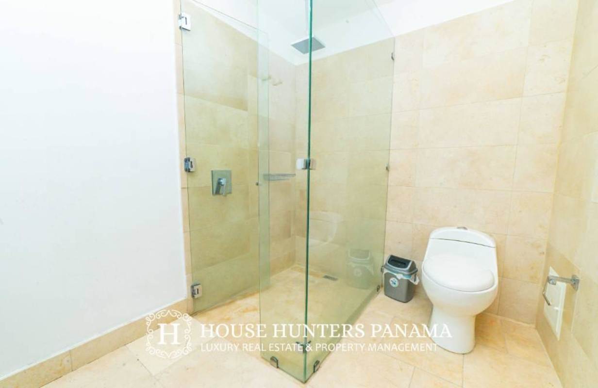 Bright living area with sectional sofa and balcony overlooking ocean skyline at The Ocean Club Punta Pacifica