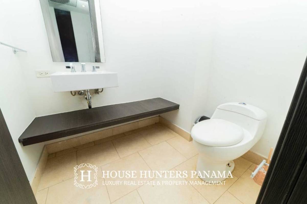 Minimalist half-bath with floating sink mirror toilet at The Ocean Club Punta Pacifica
