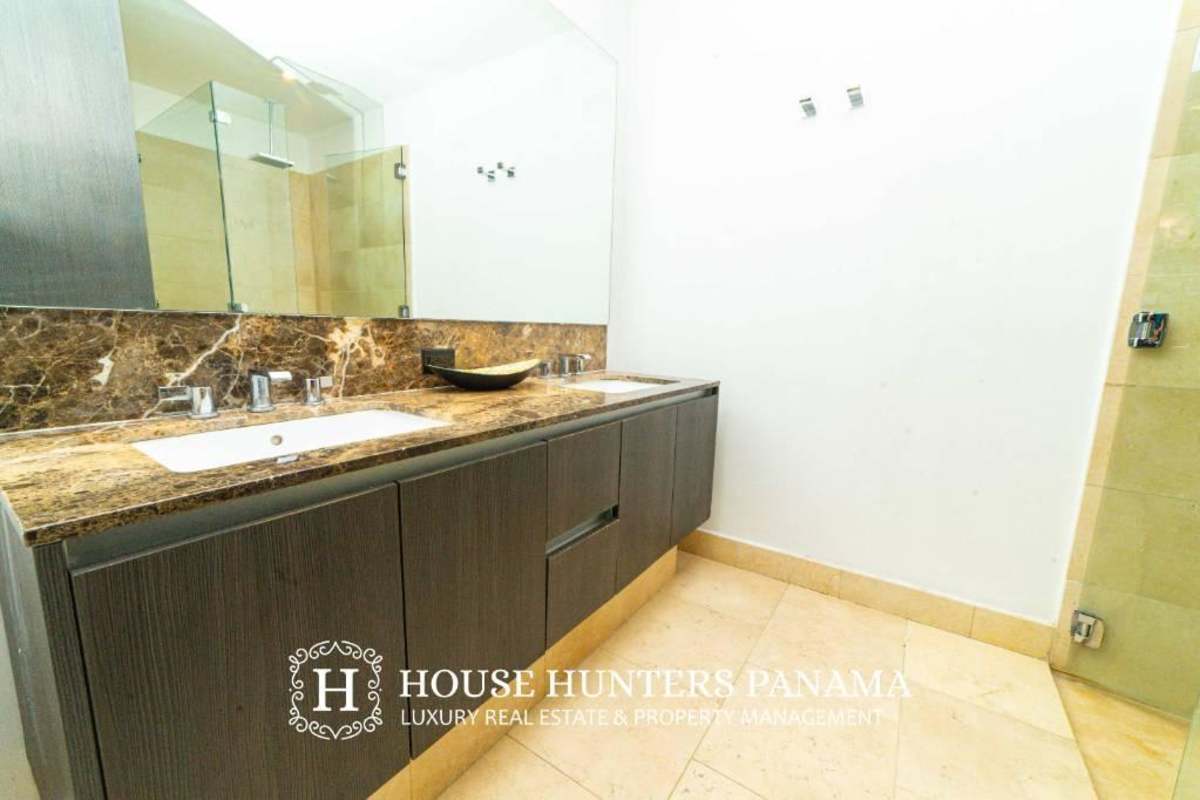Double sink bathroom marble countertops glass shower The Ocean Club Punta Pacifica Panama