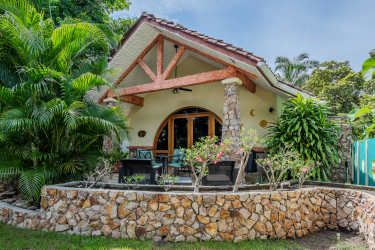 Lush tropical gardens with palm trees, bohío cabana, overlooking Pacific Ocean in Costa Esmeralda Panama