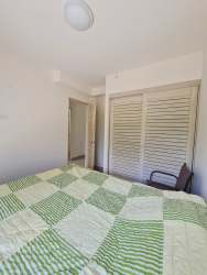 Open living area with large windows and balcony in Playa Caracol Beach Condo Panama