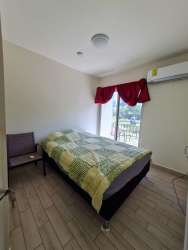 Bright bedroom with large window, air conditioning ready at Playa Caracol Condo Panama