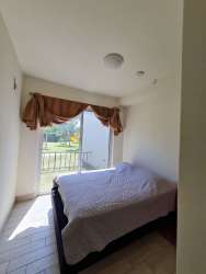 Stylish bedroom with closet and colorful surf decor in Playa Caracol apartment Panama