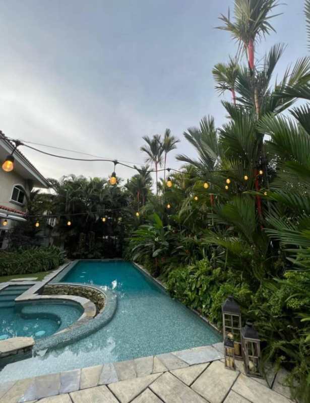 Private backyard with tropical pool, hot tub, and lush green landscaping Costa Serena Panama