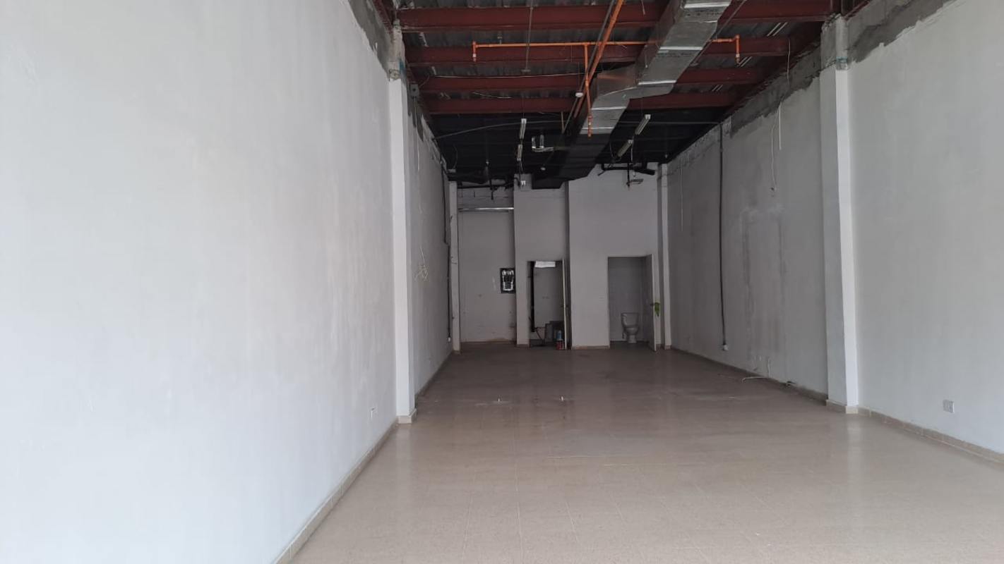 Retail interior shell space with exposed ducts and tiled floors in Star Plaza Panama