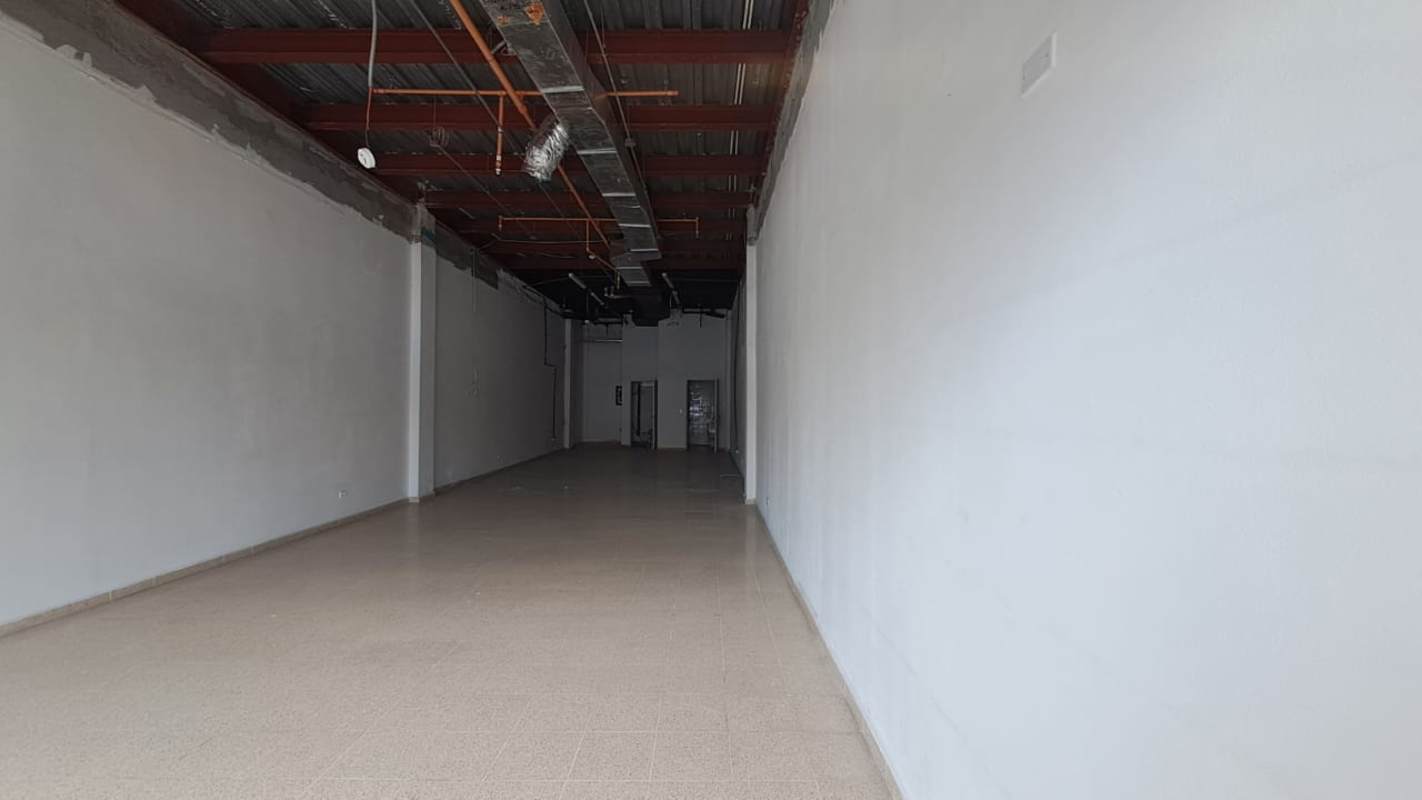 Exterior view of Star Plaza shopping center with parking lot and retail stores Costa del Este