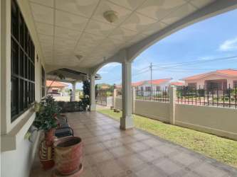 Covered porch with Mediterranean arches overlooking yard Paseo del Río Penonomé