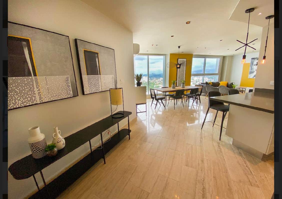 Furnished open plan dining living with large windows and city skyline view at PH Regent Costa del Este Panama