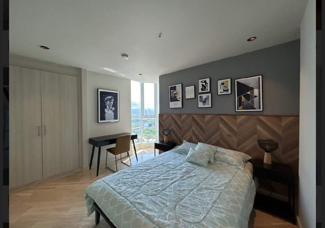 Bright furnished bedroom with large window and skyline view PH Regent Costa del Este Panama